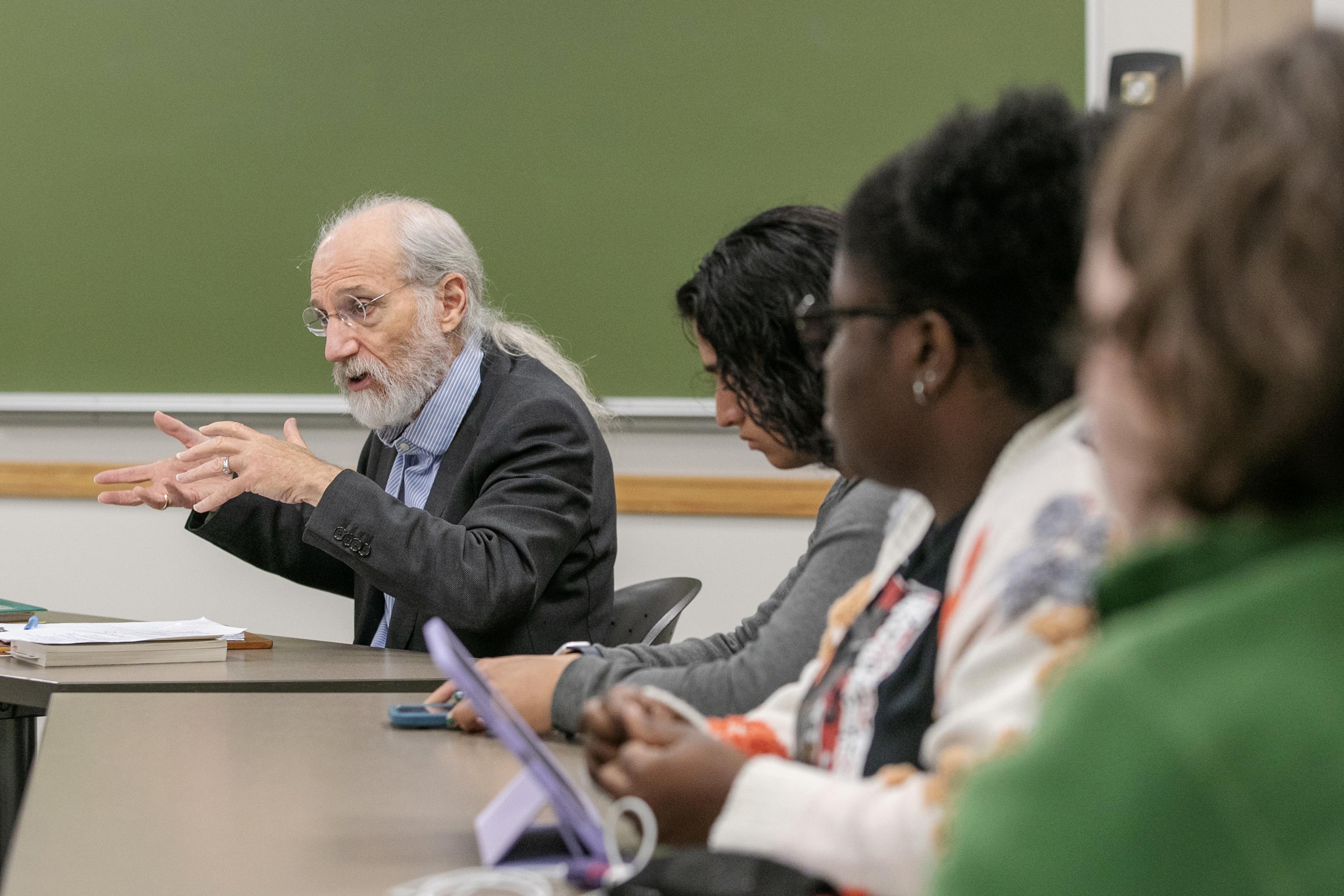 Professor Michael Marx gestures enthusiastically as his Scribner Seminar students watch.